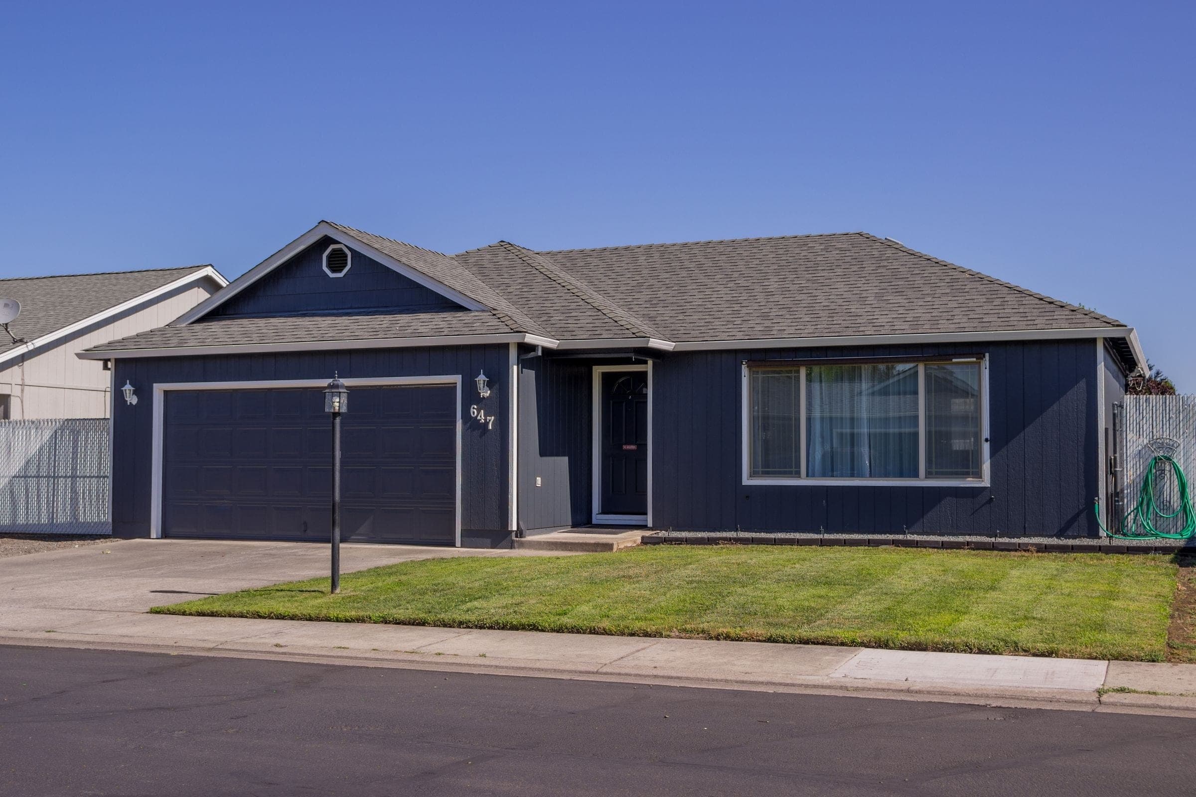 Single-story house with a two-car garage and concrete driveway